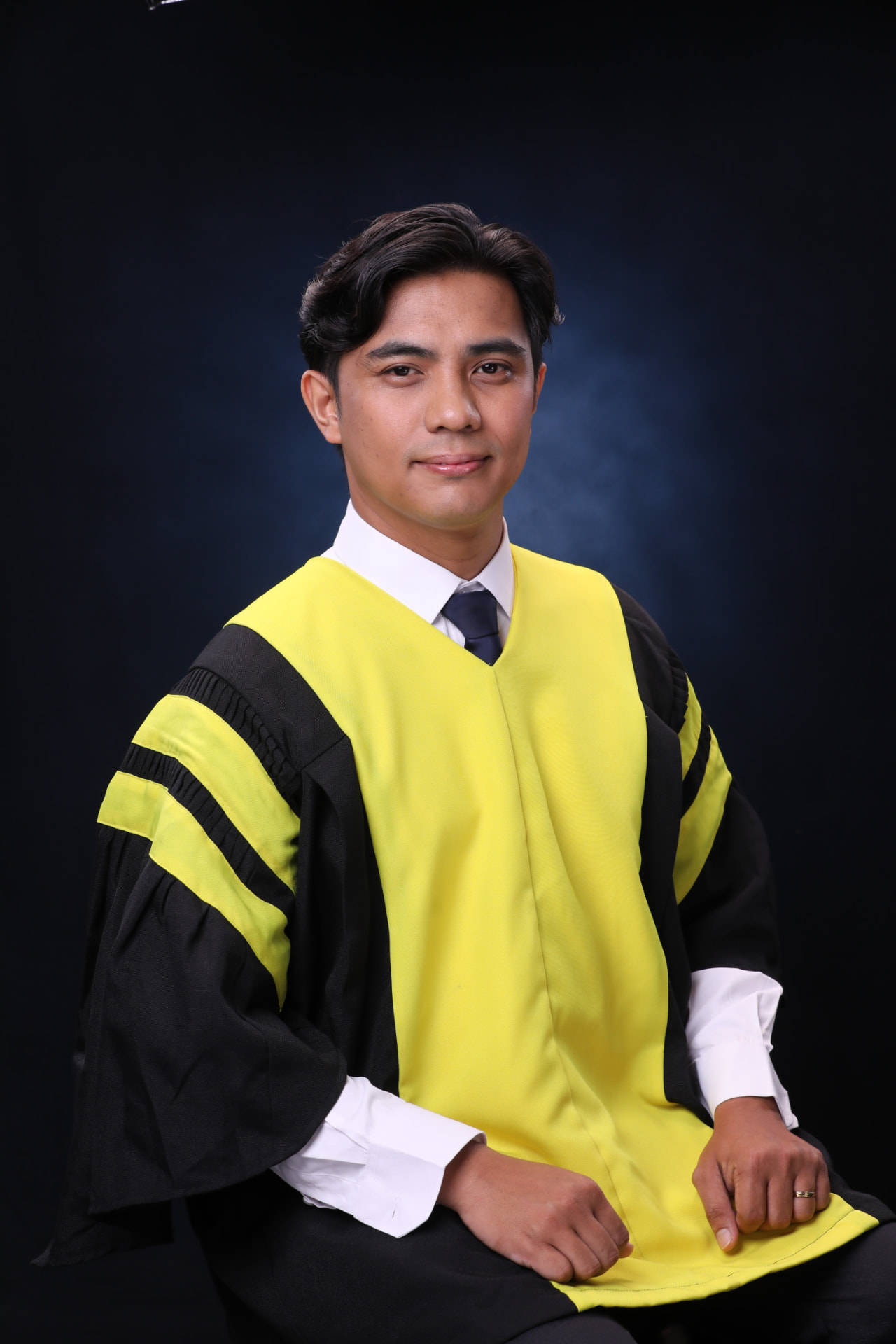 Ryan Paolo De La Cruz at his MBA graduation, wearing academic regalia